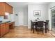 Bright dining area with wood floors, table with four chairs and sliding glass doors to the outside at 5629 Yates Garden Ln, Raleigh, NC 27606