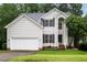 Charming two-story home with vinyl siding, well-maintained landscaping, and a two-car garage at 5629 Yates Garden Ln, Raleigh, NC 27606
