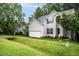 Well-manicured front yard and two-story home with vinyl siding and attached garage at 5629 Yates Garden Ln, Raleigh, NC 27606