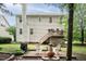 Expansive backyard with a wooden deck, stone patio, and well-maintained lawn at 5629 Yates Garden Ln, Raleigh, NC 27606