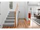 Welcoming foyer with staircase, wood flooring, and a view into the living room at 5629 Yates Garden Ln, Raleigh, NC 27606