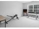 Gym features a weight rack, bench, and large window for natural light at 5629 Yates Garden Ln, Raleigh, NC 27606