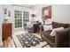 Comfortable living room with plush sofas, area rug, and large window for natural lighting at 5629 Yates Garden Ln, Raleigh, NC 27606