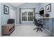 Office space features a large window, gray carpet, and a gray desk at 5629 Yates Garden Ln, Raleigh, NC 27606