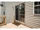 Sliding glass patio door provides easy access to the outdoor deck from the home's interior at 5629 Yates Garden Ln, Raleigh, NC 27606