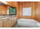 Bathroom featuring a combination shower and bathtub setup, vanity with exterior view at 612 Greenwood Rd, Chapel Hill, NC 27514