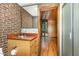 Bathroom with brick wall, vanity, wood flooring, and glass shower at 612 Greenwood Rd, Chapel Hill, NC 27514