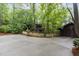 House with large driveway and garage surrounded by trees at 612 Greenwood Rd, Chapel Hill, NC 27514