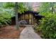Unique modern home with brick and wood exterior nestled in a lush wooded lot with mature landscaping at 612 Greenwood Rd, Chapel Hill, NC 27514