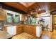 Well-equipped kitchen features wood cabinets, stainless steel appliances, breakfast area, and wood ceiling with skylight at 612 Greenwood Rd, Chapel Hill, NC 27514