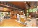 Spacious living room featuring hardwood floors, wood ceiling, brick walls and fireplace, and floor-to-ceiling windows at 612 Greenwood Rd, Chapel Hill, NC 27514