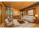 Elegant living room with hardwood floors, wood-paneled walls, and access to the outdoors at 612 Greenwood Rd, Chapel Hill, NC 27514
