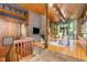 Open-concept living room with beautiful stone floor entry, hardwood floors, wood ceilings and a brick fireplace at 612 Greenwood Rd, Chapel Hill, NC 27514