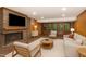 Cozy living room with brick fireplace, comfortable seating, and views of nature at 612 Greenwood Rd, Chapel Hill, NC 27514