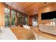 Wood paneled main bedroom with hardwood floors, exterior view, and easy access to the adjoining rooms at 612 Greenwood Rd, Chapel Hill, NC 27514