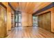Spacious room featuring wood walls, hardwood flooring and large windows at 612 Greenwood Rd, Chapel Hill, NC 27514