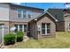 Exterior view of brick and vinyl siding with a small patio and green lawn at 628 Denhoff Dr, Cary, NC 27519