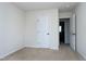 Neutral carpeted bedroom featuring white trim and a large closet at 628 Denhoff Dr, Cary, NC 27519