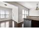 Dining area featuring stainless steel dishwasher and countertops, with a view of the living room and door to yard at 628 Denhoff Dr, Cary, NC 27519