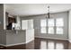Bright dining area featuring hardwood floors, a chandelier, and windows for natural light at 628 Denhoff Dr, Cary, NC 27519