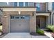 Attached one-car garage with brick facade and clean concrete driveway leading to a cozy entrance at 628 Denhoff Dr, Cary, NC 27519