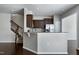 Eat-in kitchen with stainless steel appliances, granite countertops, dark brown cabinets and a breakfast bar at 628 Denhoff Dr, Cary, NC 27519