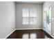 Bright room featuring wood floors, large windows, and a glass paneled door at 628 Denhoff Dr, Cary, NC 27519