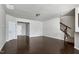Spacious open-concept living room with hardwood floors, staircase, and an open kitchen counter at 628 Denhoff Dr, Cary, NC 27519