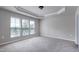 Spacious main bedroom featuring a trey ceiling and many windows at 628 Denhoff Dr, Cary, NC 27519