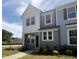 Charming townhome with light gray siding, black trim, and manicured front lawn at 6441 Granite Quarry Dr, Raleigh, NC 27610