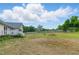 Spacious backyard featuring green grass, a partial view of the deck, and a wooden perimeter fence at 71 Havistock Ct, Cameron, NC 28326