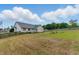 Wide backyard with a combination of lush and dry grass, offering plenty of space and a wooden fence border at 71 Havistock Ct, Cameron, NC 28326