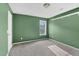 A cozy bedroom with green walls, carpeted floors, and a bright window for natural light at 71 Havistock Ct, Cameron, NC 28326