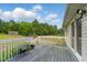 An outdoor wooden deck featuring views of the backyard and mature trees at 71 Havistock Ct, Cameron, NC 28326