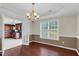 A dining room with hardwood floors that opens up to the kitchen at 71 Havistock Ct, Cameron, NC 28326