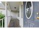 Detailed view of the front door from the porch, highlighting the decorative glass and hardware at 71 Havistock Ct, Cameron, NC 28326