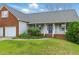 Inviting front exterior featuring a covered porch, brick accents, and manicured landscaping at 71 Havistock Ct, Cameron, NC 28326
