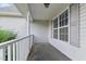 Covered front porch showing gray vinyl siding, gray shutters, and a white railing at 71 Havistock Ct, Cameron, NC 28326