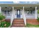 Close-up of the front porch showcasing brick steps, white railings, and a decorative front door at 71 Havistock Ct, Cameron, NC 28326