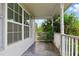 Spacious covered front porch with gray flooring, white railings, and views of the yard at 71 Havistock Ct, Cameron, NC 28326