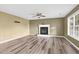 Bright living room boasts a fireplace, ceiling fan, and large windows for natural light at 71 Havistock Ct, Cameron, NC 28326
