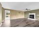 Spacious living room features a fireplace, ceiling fan, and stylish wood-look flooring at 71 Havistock Ct, Cameron, NC 28326