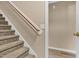 Carpeted staircase with wooden handrail and a view of the wall and adjacent room at 71 Havistock Ct, Cameron, NC 28326