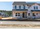 Under construction exterior showing two-story townhome with Tyvek wrap and visible framing at 711 Chandler Stone Dr, Zebulon, NC 27597
