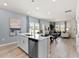 Modern kitchen featuring white cabinets, stainless steel appliances, and a center island with bar stool seating at 711 Chandler Stone Dr, Zebulon, NC 27597