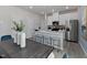 Open-concept kitchen featuring white cabinets, stainless appliances, and a spacious island with bar stool seating at 711 Chandler Stone Dr, Zebulon, NC 27597
