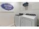 Functional laundry room with modern washer and dryer units and ample storage space at 711 Chandler Stone Dr, Zebulon, NC 27597