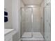 Modern tiled shower with glass enclosure, providing a sleek and functional design at 711 Chandler Stone Dr, Zebulon, NC 27597
