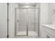 Bathroom with a glass-enclosed shower with tile surround and modern fixtures at 713 Chandler Stone Dr, Zebulon, NC 27597