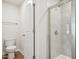 Bathroom featuring a glass shower enclosure, toilet, and towel rack at 713 Chandler Stone Dr, Zebulon, NC 27597